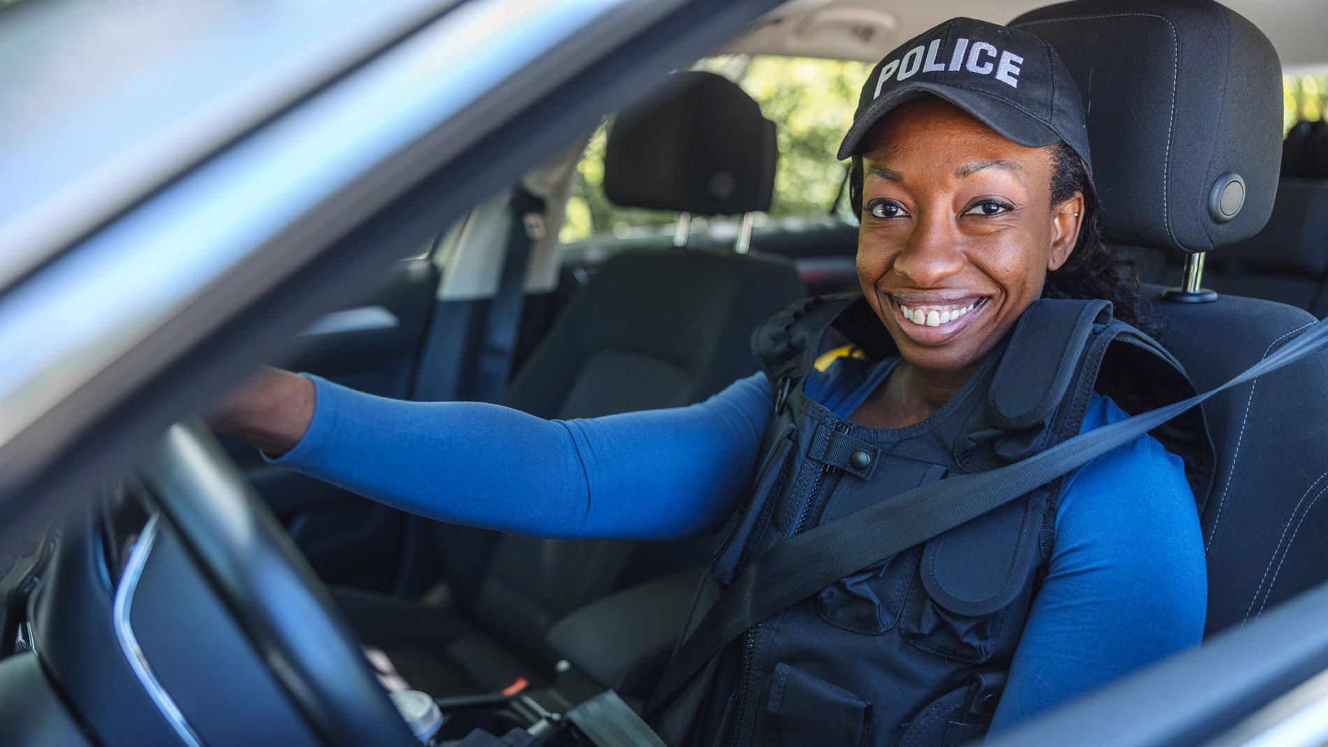 Police officer smiling in car